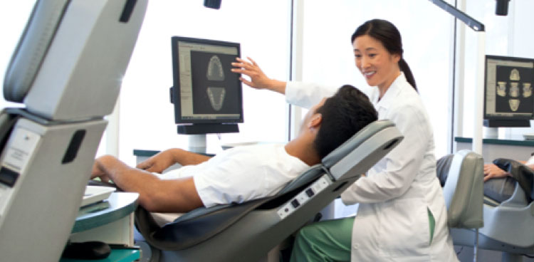 A dentist reviews X-rays with patient