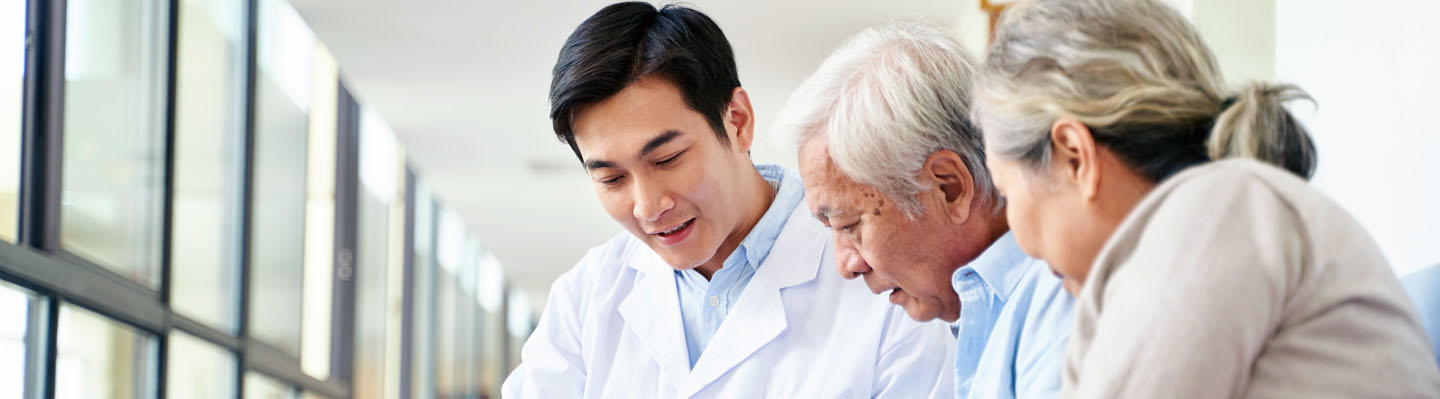 A doctor consults with an elderly couple