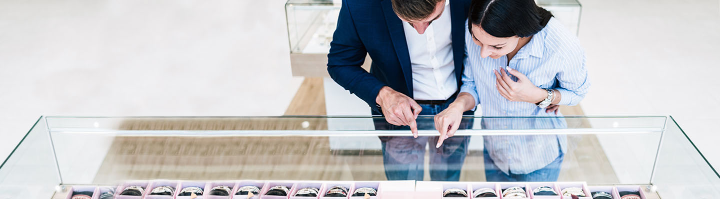 A young couple shops for engagement rings