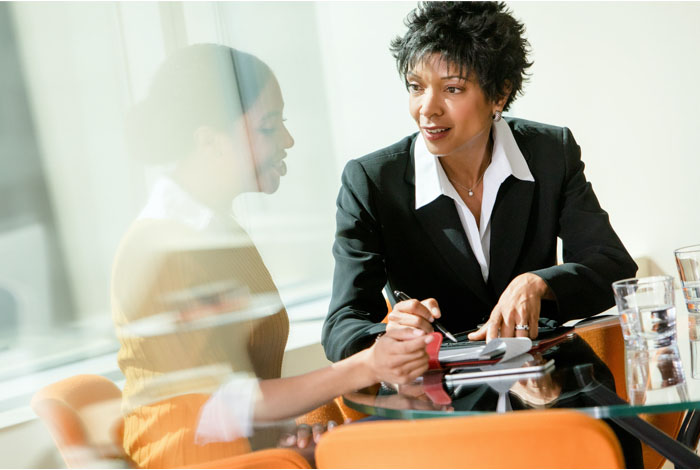 Wells Fargo relationship manager sits with a business owner