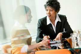 Wells Fargo relationship manager sits with a business owner