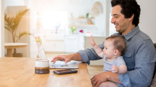 Father and his baby on the laptop